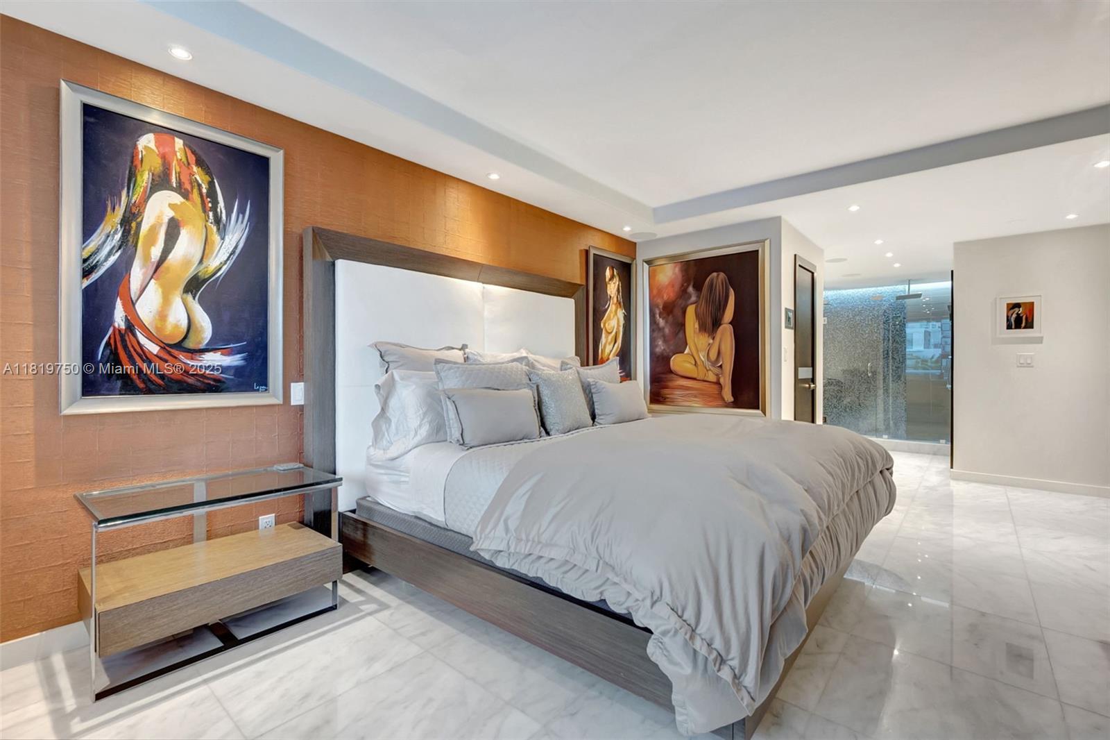 2301 Collins Avenue, Unit 307 Miami Beach, FL 33139 - Photo 11 of 17 a spacious bedroom with a bed and lamp