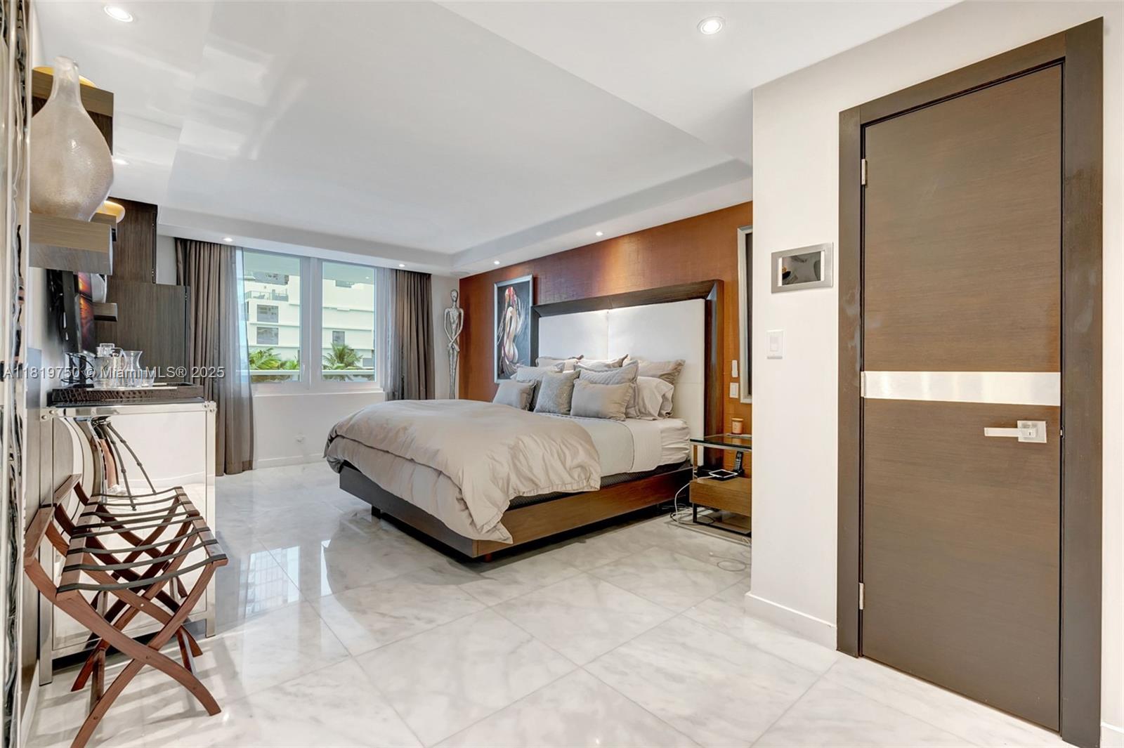 2301 Collins Avenue, Unit 307 Miami Beach, FL 33139 - Photo 12 of 17 a bedroom with a bed and large windows