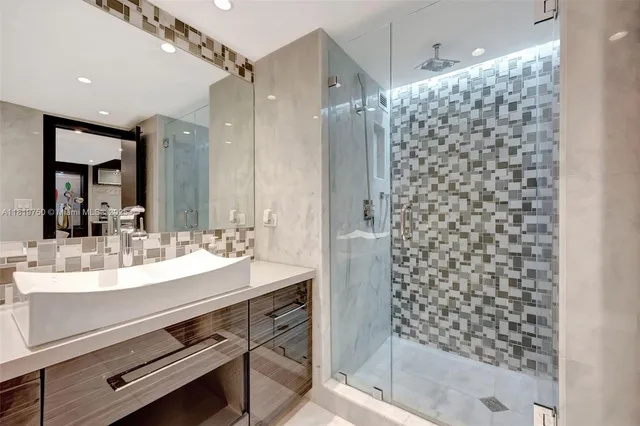 a bathroom with a shower and a sink