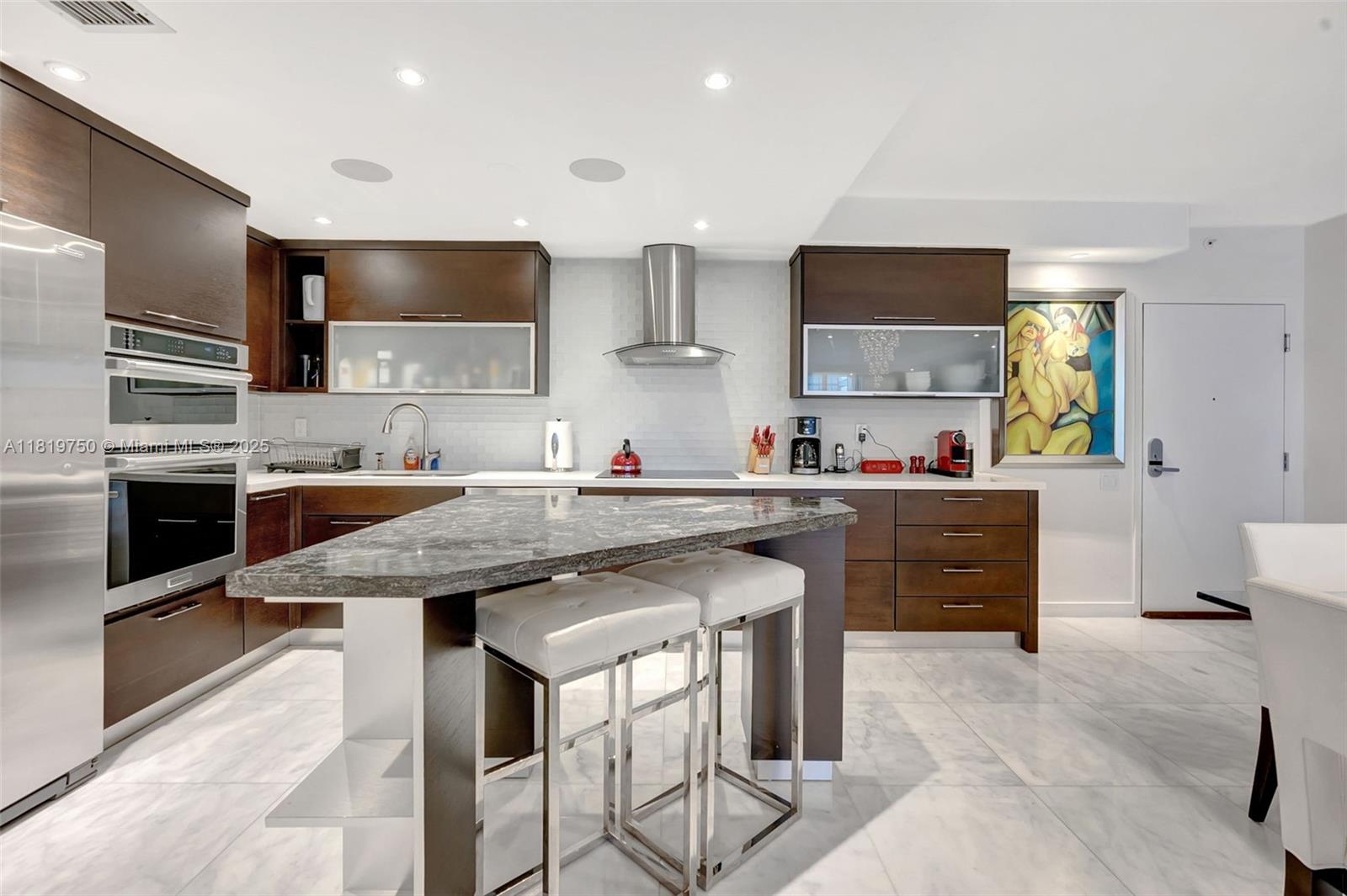 2301 Collins Avenue, Unit 307 Miami Beach, FL 33139 - Photo 9 of 17 a kitchen with stainless steel appliances granite countertop a sink stove and refrigerator