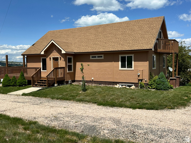 12 Crook Street Fish Haven, ID 83287 - Photo 34 of 35 View of front of house featuring a shingled roof and a front lawn