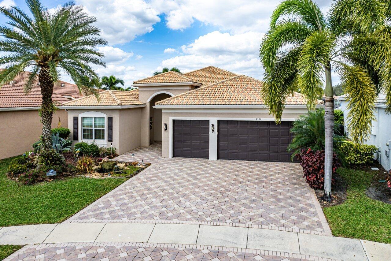 9047 Ribbons Ridge Point Boynton Beach, FL 33473 - Photo 1 of 37 a front view of a house with a garden
