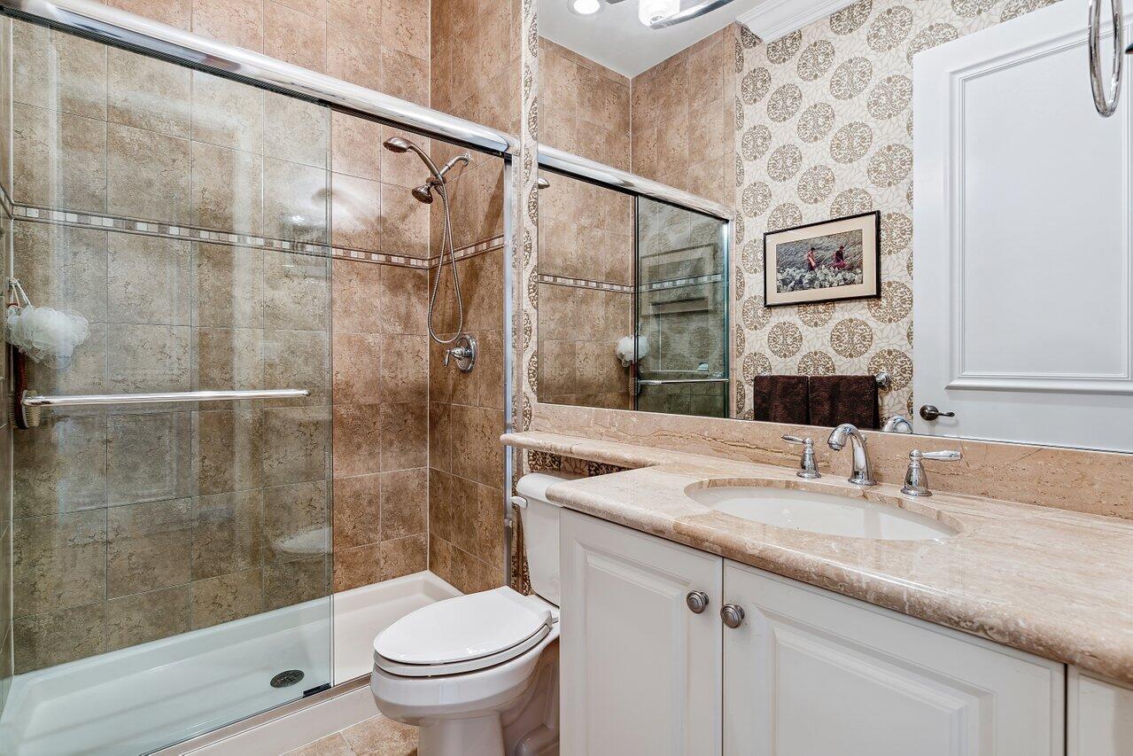 9047 Ribbons Ridge Point Boynton Beach, FL 33473 - Photo 13 of 37 a bathroom with a granite countertop sink toilet and shower