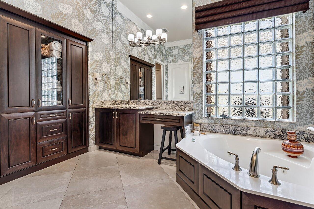 9047 Ribbons Ridge Point Boynton Beach, FL 33473 - Photo 16 of 37 a bathroom with a granite countertop sink a mirror and a bathtub
