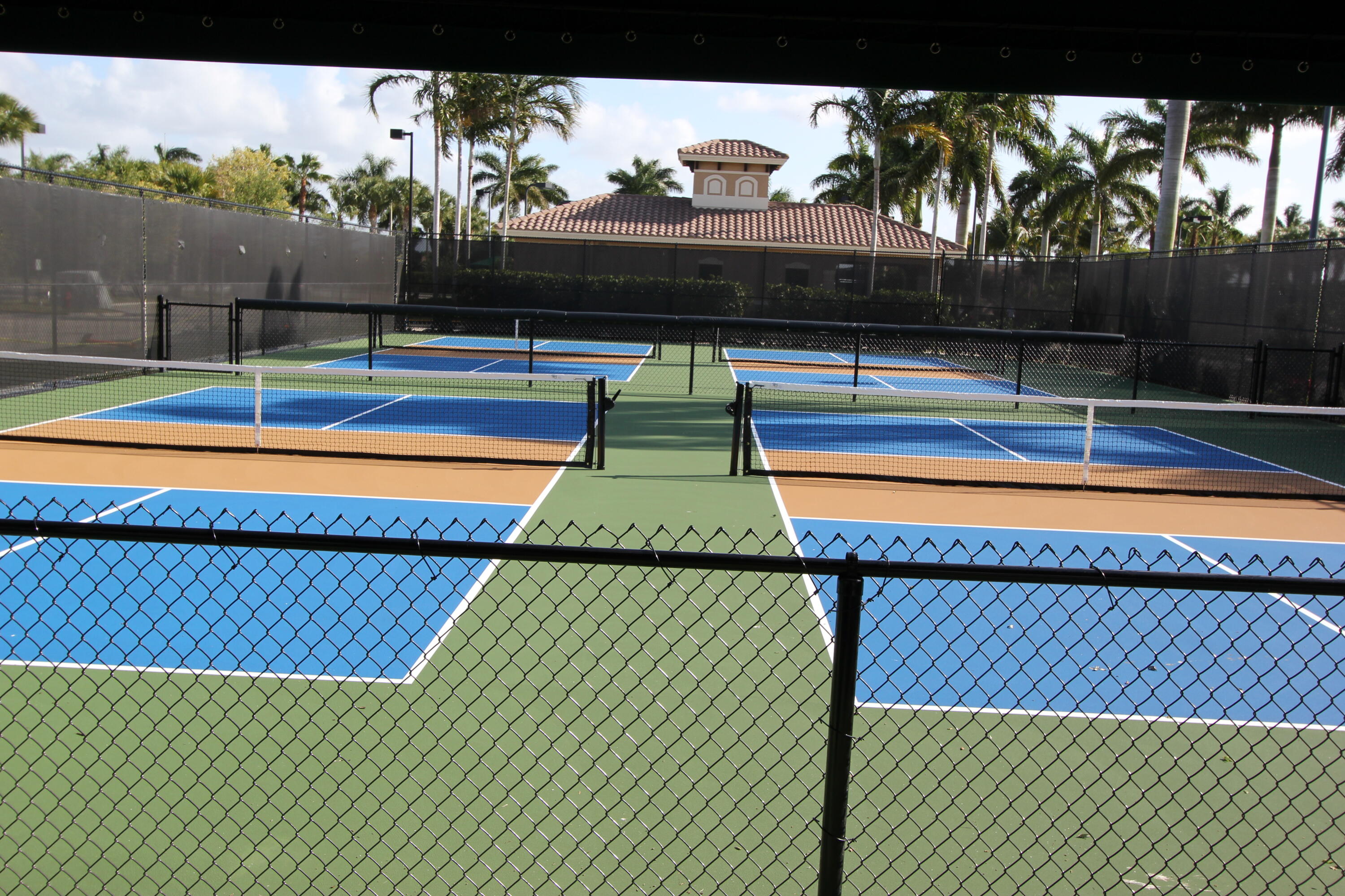9047 Ribbons Ridge Point Boynton Beach, FL 33473 - Photo 28 of 37 a view of swimming pool with seating area and trees in the background