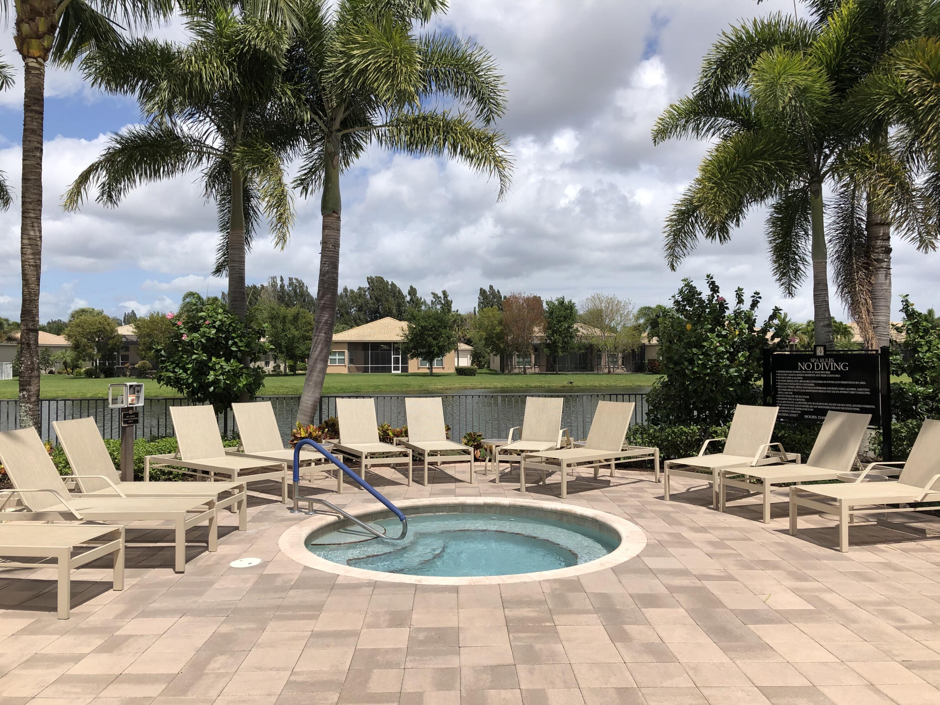 9047 Ribbons Ridge Point Boynton Beach, FL 33473 - Photo 34 of 37 a view of a swimming pool with chairs