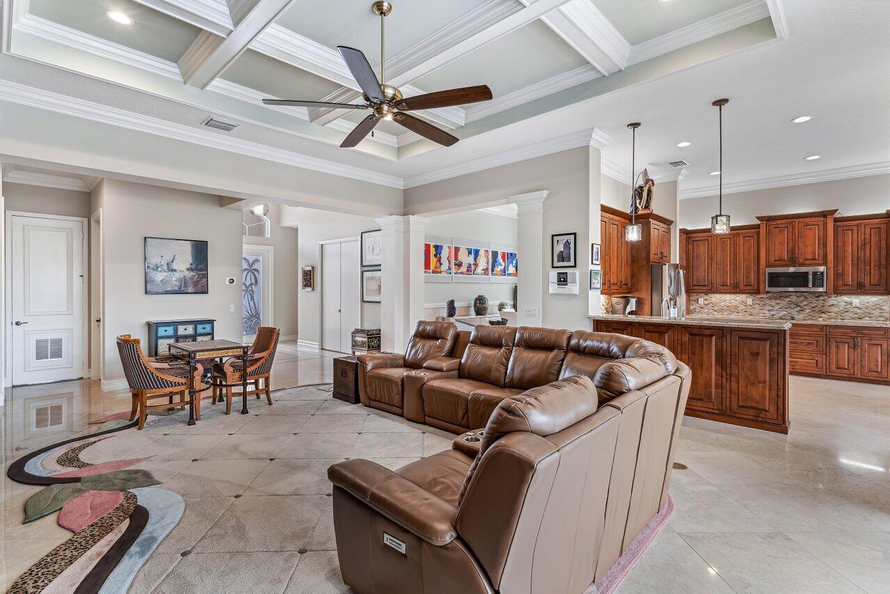 9047 Ribbons Ridge Point Boynton Beach, FL 33473 - Photo 4 of 37 a living room with furniture kitchen view and a chandelier