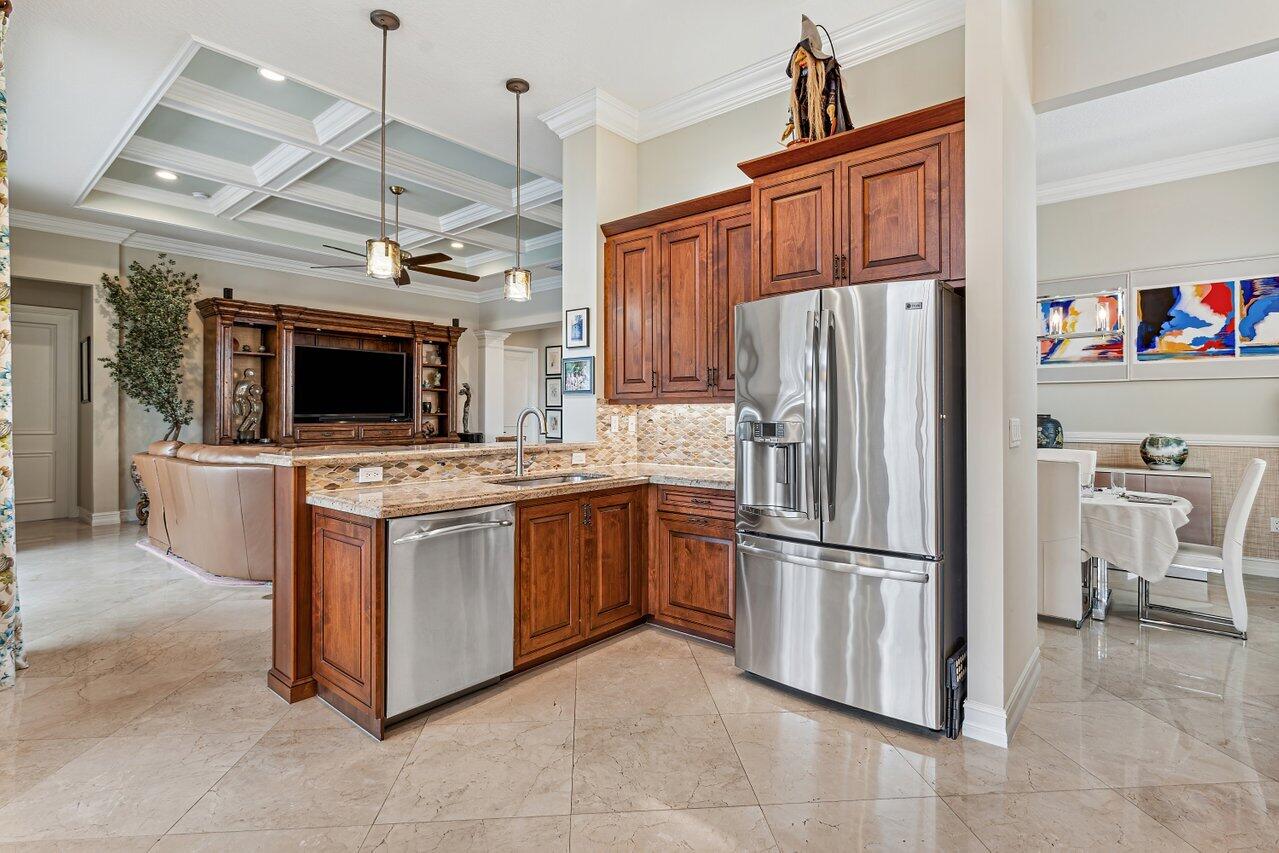 9047 Ribbons Ridge Point Boynton Beach, FL 33473 - Photo 7 of 37 a kitchen with stainless steel appliances granite countertop a refrigerator oven a sink and a refrigerator