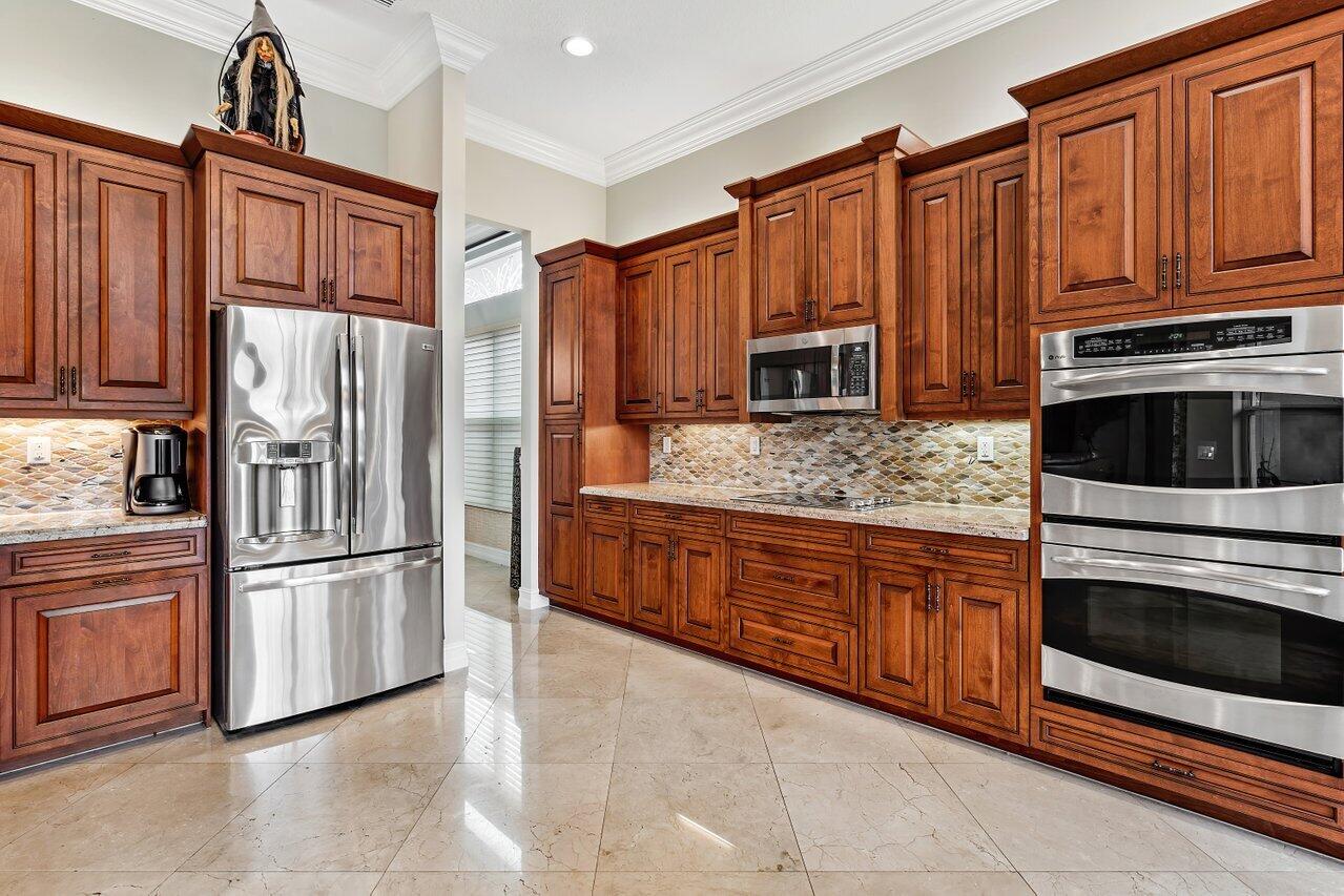 9047 Ribbons Ridge Point Boynton Beach, FL 33473 - Photo 9 of 37 a kitchen with stainless steel appliances granite countertop a refrigerator oven a sink and dishwasher