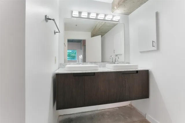 a bathroom with a sink vanity and a mirror