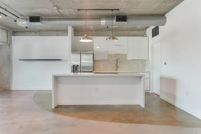 a kitchen with a sink cabinets and stainless steel appliances