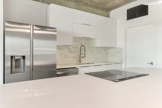 a close view of a sink and cabinets