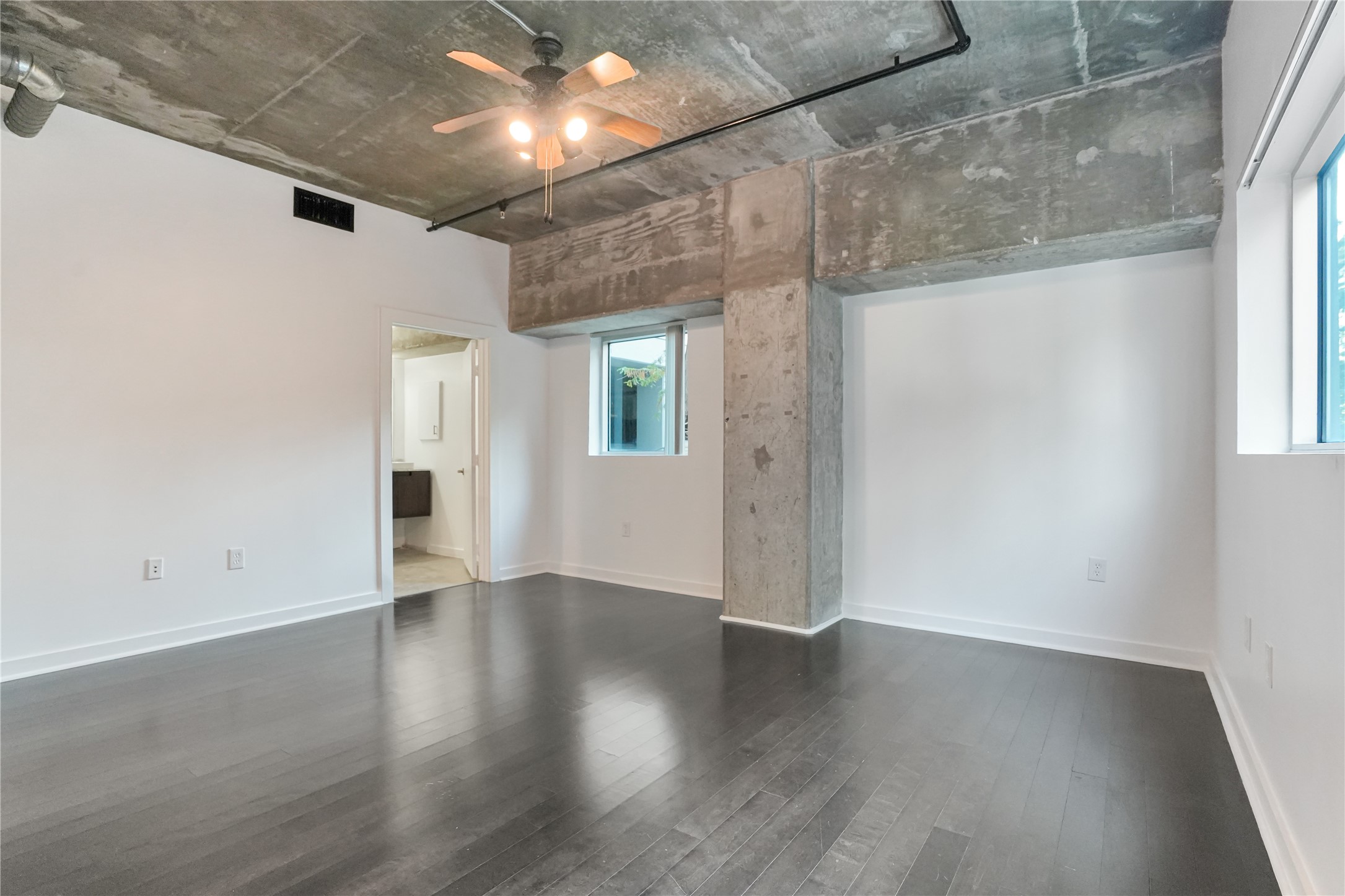 2000 Bagby Street, Unit 2401 Houston, TX 77002 - Photo 6 of 38 an empty room with wooden floor and windows