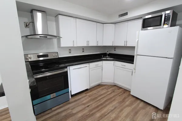 a bathroom with a toilet a sink a mirror and bathtub