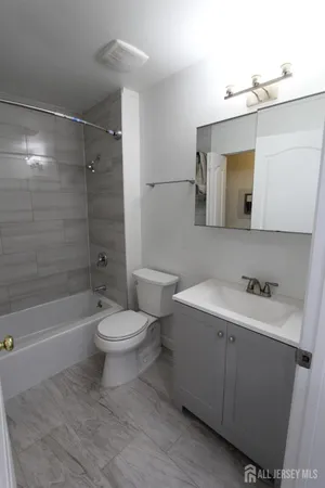 a bathroom with a toilet and a bath tub