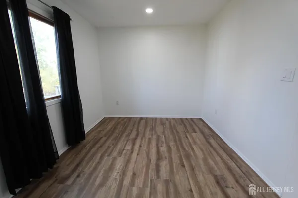 a view of a small space with wooden floor and porch