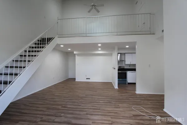 a view of a room with wooden floor and staircase