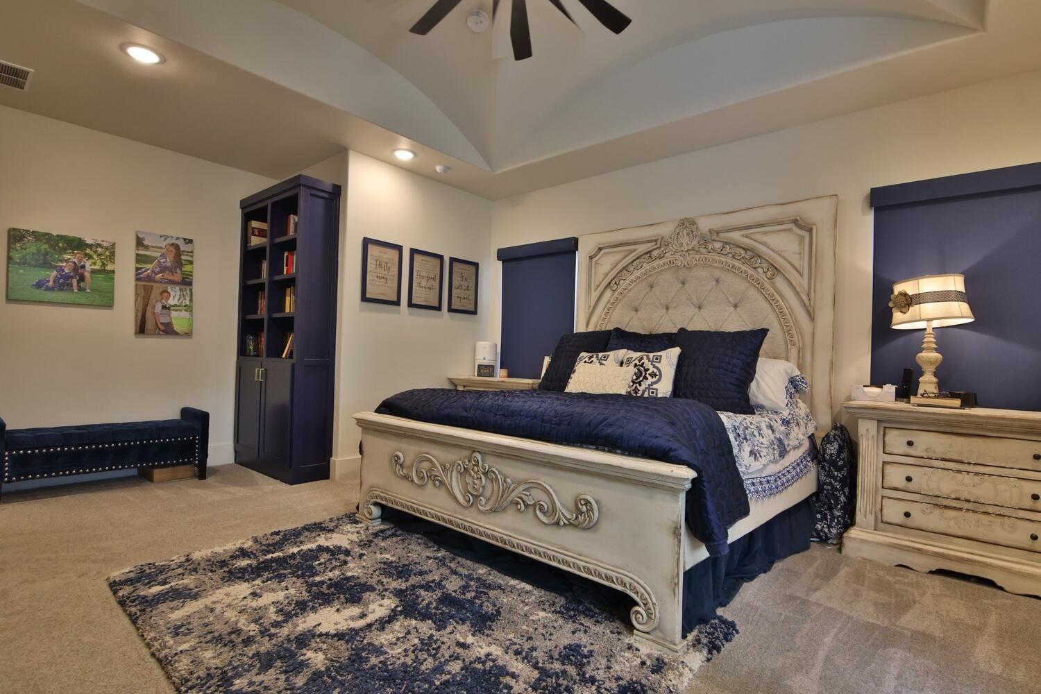 4611 139th Street Lubbock, TX 79424 - Photo 13 of 38 a bedroom with a bed and a chandelier