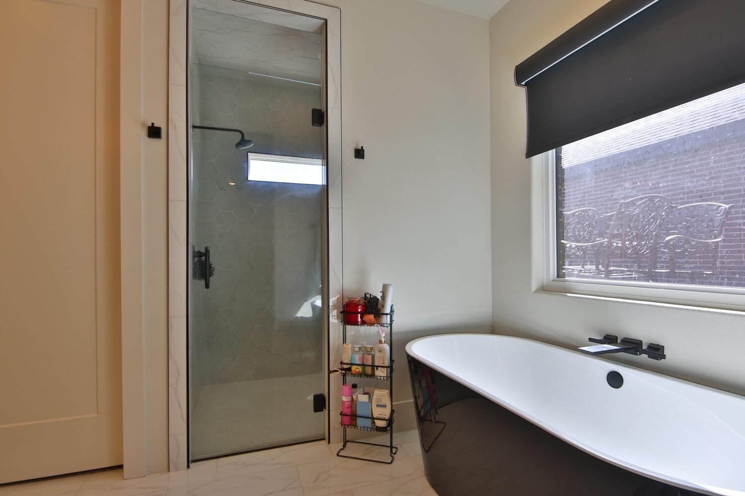 4611 139th Street Lubbock, TX 79424 - Photo 15 of 38 a bathroom with a tub sink and shower