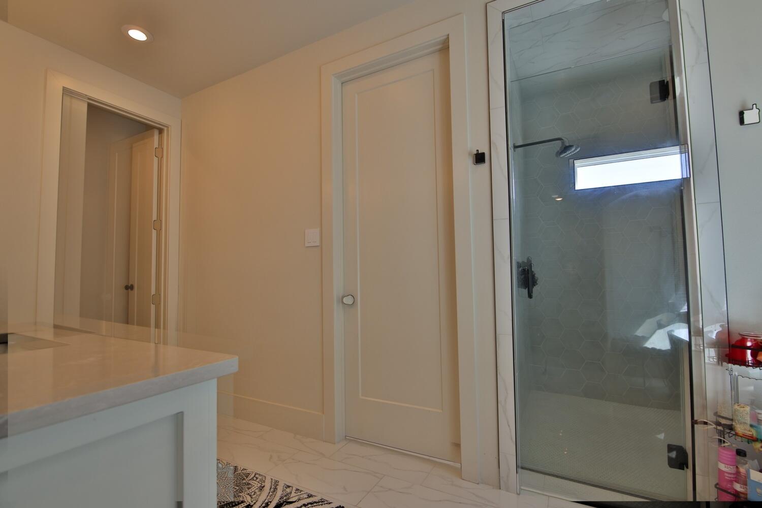 4611 139th Street Lubbock, TX 79424 - Photo 16 of 38 a bathroom with a granite countertop sink and shower