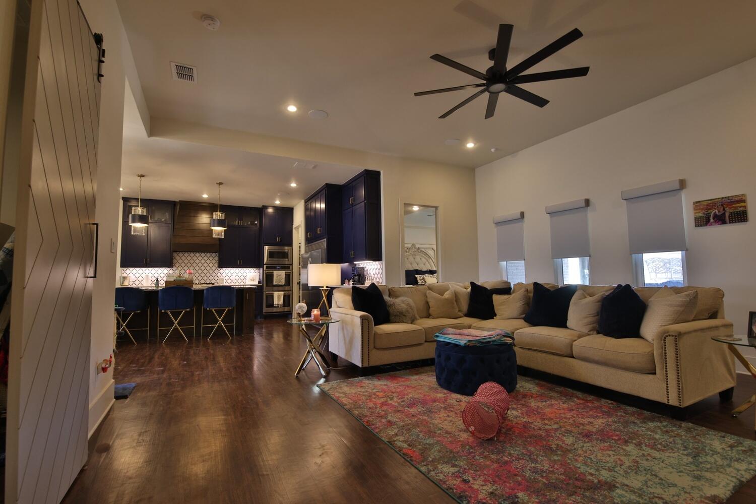 4611 139th Street Lubbock, TX 79424 - Photo 20 of 38 a living room with furniture and a dining table with wooden floor