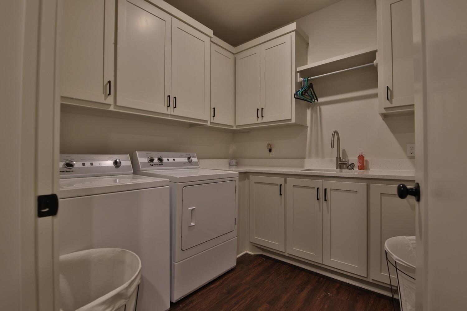 4611 139th Street Lubbock, TX 79424 - Photo 25 of 38 a utility room with cabinets washer and dryer