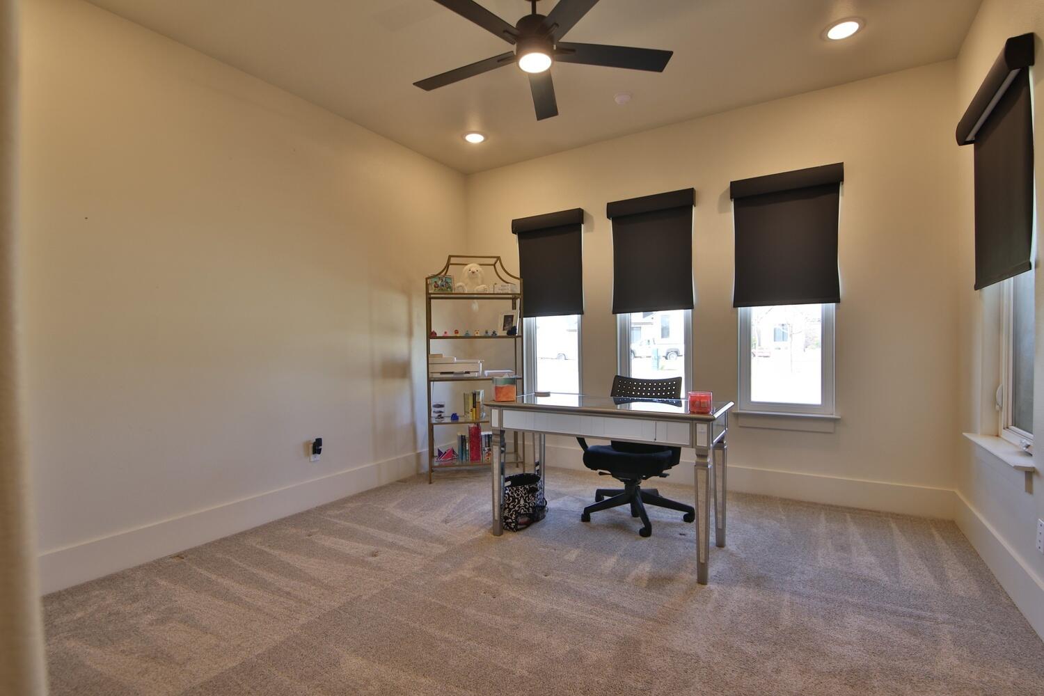 4611 139th Street Lubbock, TX 79424 - Photo 27 of 38 a view of a workspace with furniture and a window