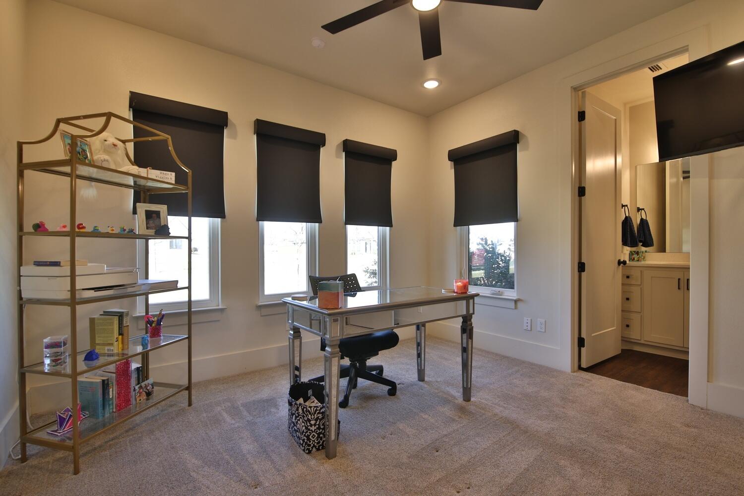 4611 139th Street Lubbock, TX 79424 - Photo 28 of 38 a view of a workspace with furniture and a window