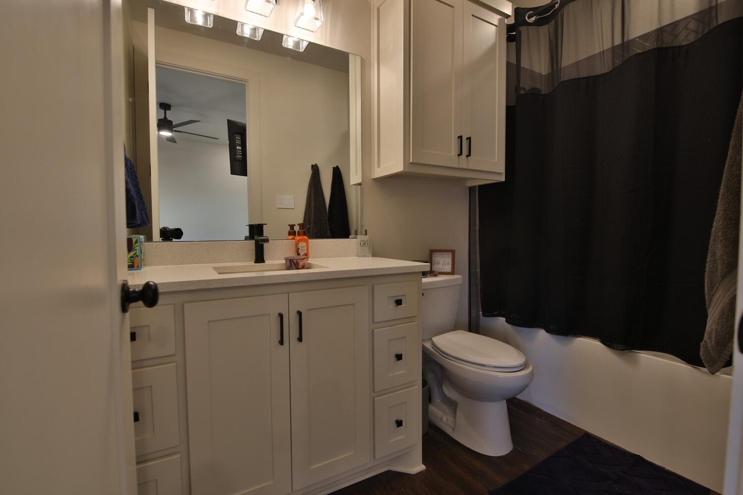 4611 139th Street Lubbock, TX 79424 - Photo 30 of 38 a bathroom with a sink toilet and mirror
