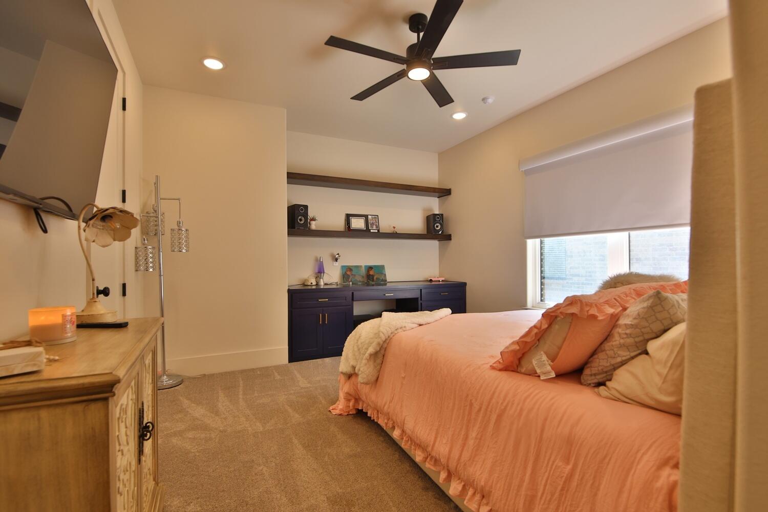 4611 139th Street Lubbock, TX 79424 - Photo 32 of 38 a bedroom with a bed and a flat screen tv