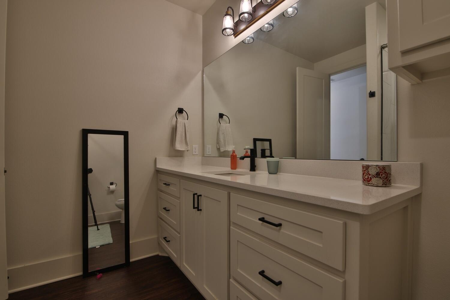 4611 139th Street Lubbock, TX 79424 - Photo 37 of 38 a bathroom with a sink double vanity and a mirror