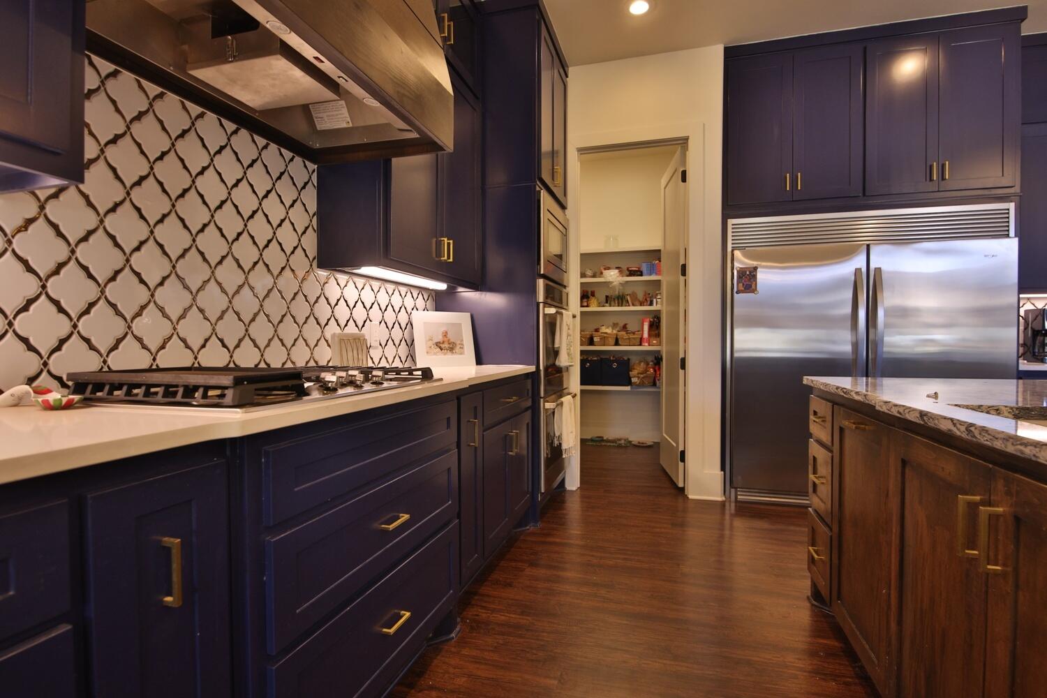 4611 139th Street Lubbock, TX 79424 - Photo 6 of 38 a kitchen with granite countertop wooden cabinets and stainless steel appliances