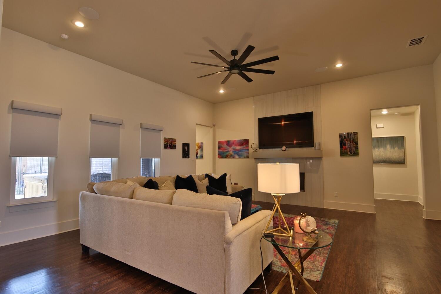 4611 139th Street Lubbock, TX 79424 - Photo 8 of 38 a living room with furniture a flat screen tv and wooden floor