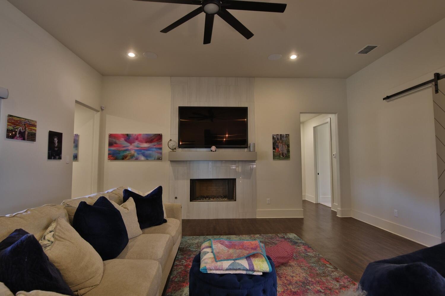 4611 139th Street Lubbock, TX 79424 - Photo 9 of 38 a living room with furniture and a flat screen tv