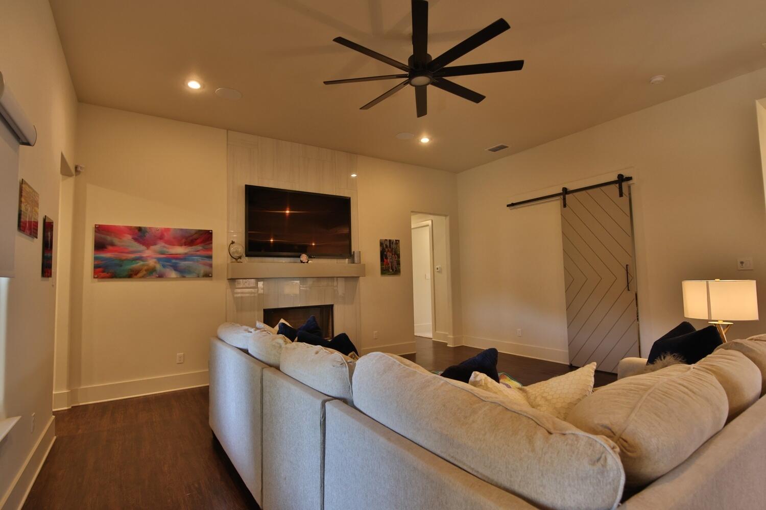 4611 139th Street Lubbock, TX 79424 - Photo 10 of 38 a living room with furniture and a flat screen tv