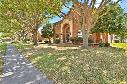 a brick building with trees in front of it