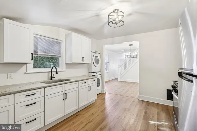 a kitchen with stainless steel appliances granite countertop a sink and wooden cabinets