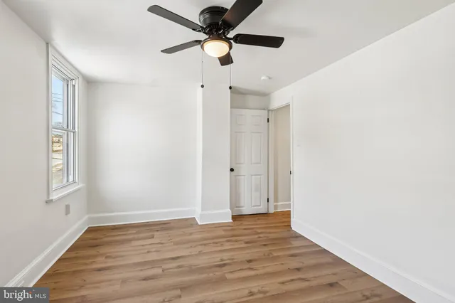 a bathroom with a tub a sink and a window