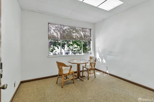 a dining room with furniture and a window