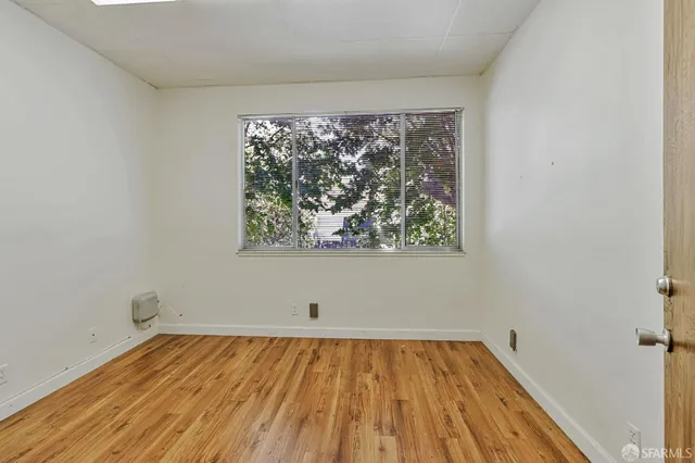 a view of a room with wooden floor and city view
