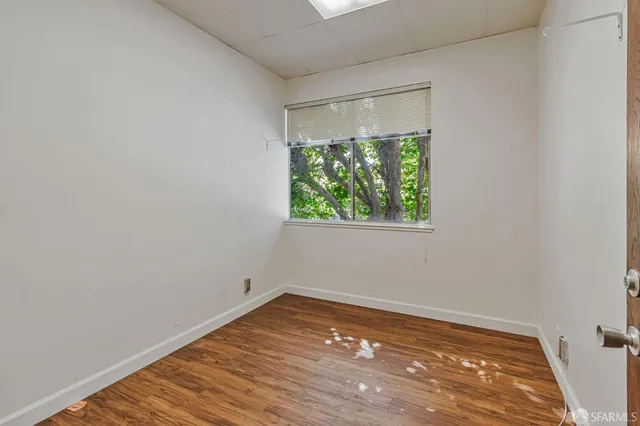 a view of a room with wooden floor and window
