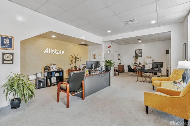 a living room with furniture gym equipment and a large window