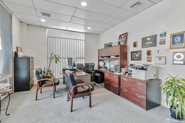 a work room with furniture and a window