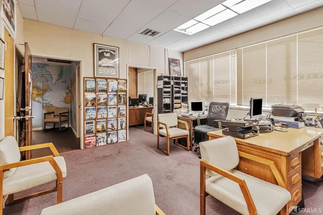 a room with furniture pool table and large windows