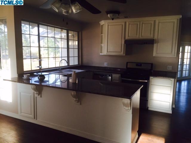 355 South Cornucopia Road Exeter, CA 93221 - Photo 3 of 26 a kitchen with granite countertop a sink and a stove