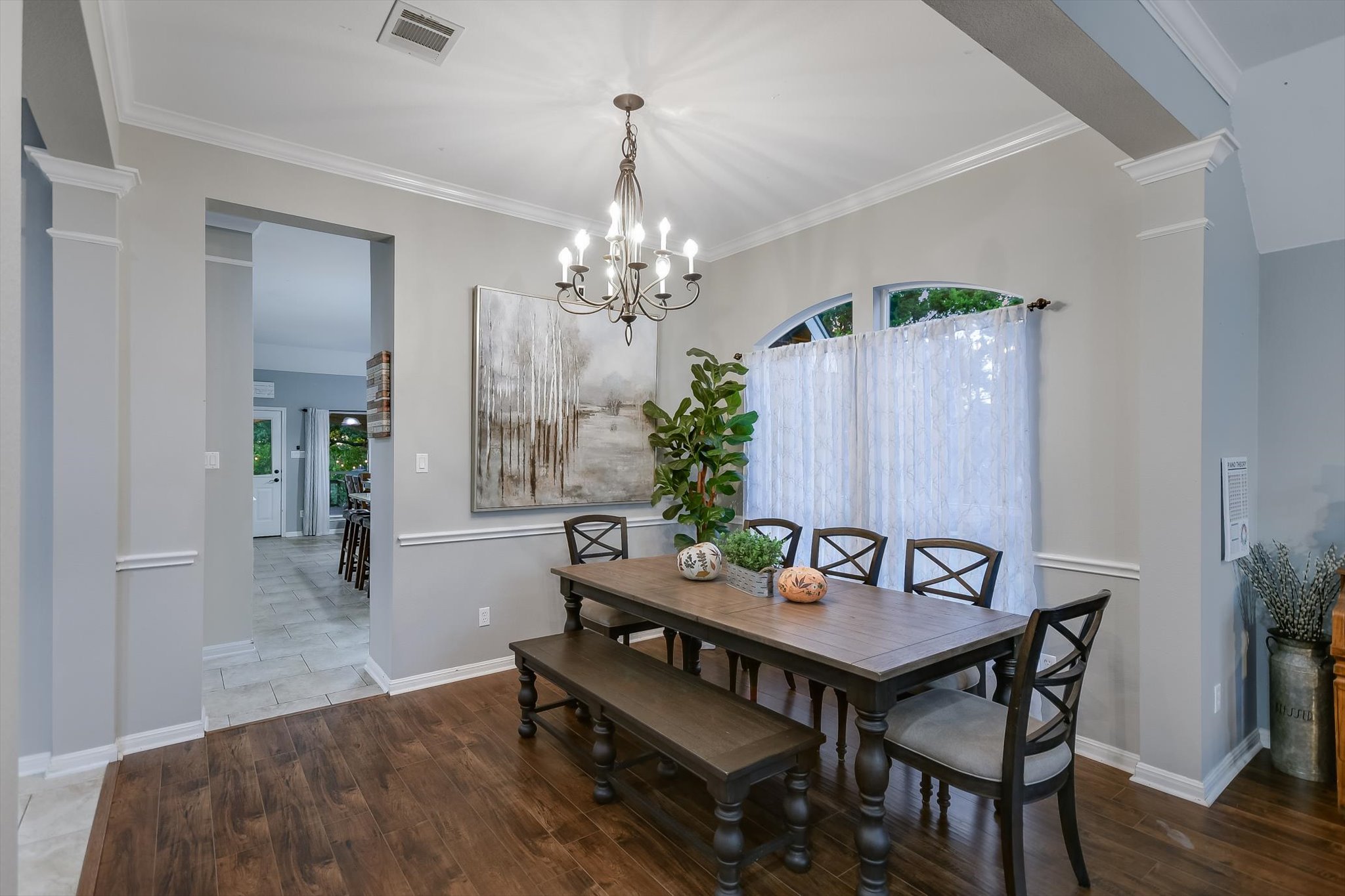 300 Wesley Ridge Drive Spicewood, TX 78669 - Photo 9 of 40 The formal dining room is an inviting space with a charming chandelier and sunlight pouring in through the large window—perfect for hosting family meals or gatherings.