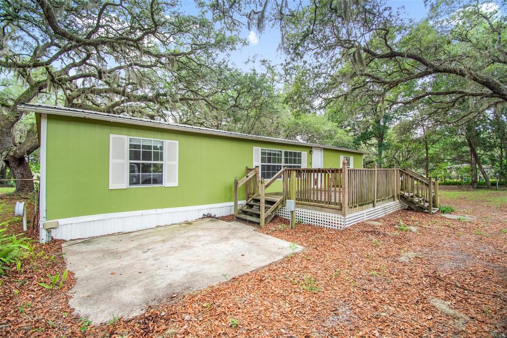 156 Kingfish Road Pomona Park, FL 32181 - Photo 4 of 55 a backyard of a house with barbeque oven and table and chairs