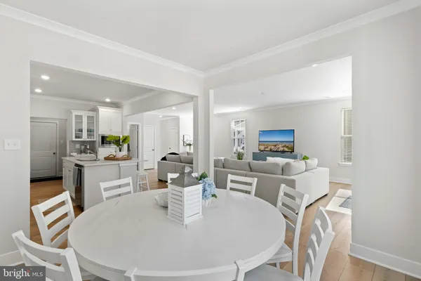 a large white kitchen with a white table and chairs