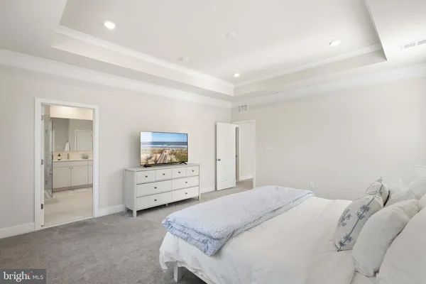 a bedroom with a bed and dresser