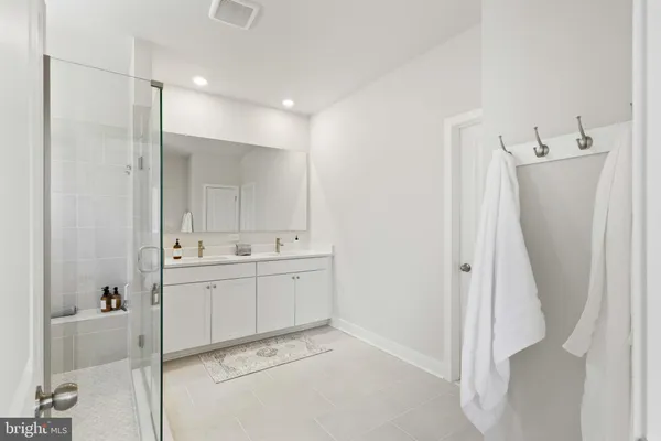 a bathroom with a tub sink and mirror